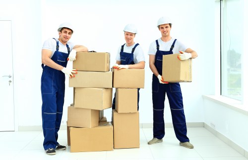 Removals team handling furniture in a Stockwell residential street