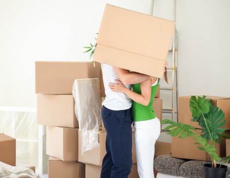 Packed office equipment and labelled cartons ready for a business move in Stockwell